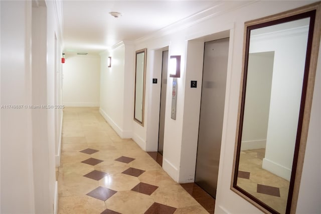 hallway featuring crown molding and baseboards