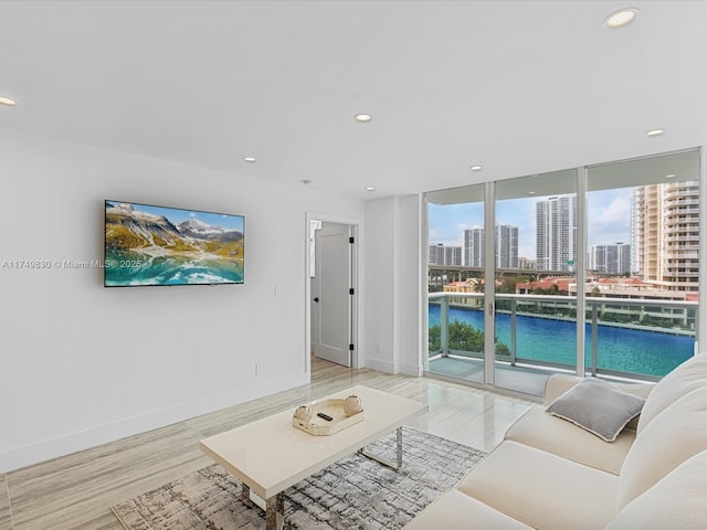 living area featuring expansive windows, baseboards, and recessed lighting