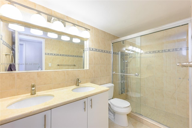 full bathroom featuring toilet, tasteful backsplash, tile walls, and a sink