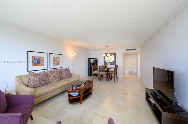 living room featuring a chandelier, visible vents, crown molding, and a textured ceiling