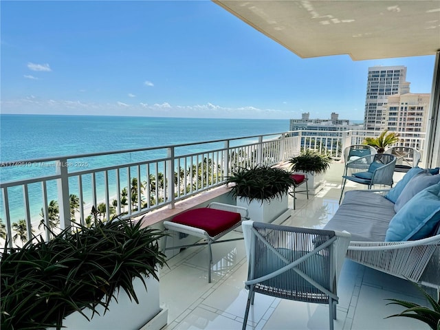 balcony with a beach view, outdoor lounge area, and a water view