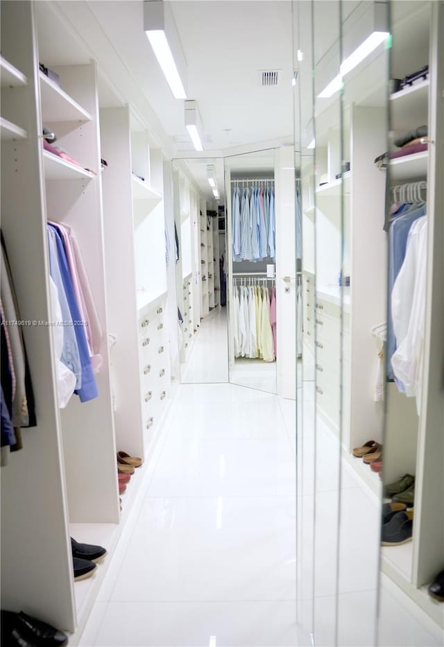 spacious closet with visible vents and light tile patterned flooring