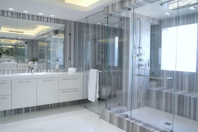 full bathroom featuring toilet, a stall shower, vanity, and tile patterned floors