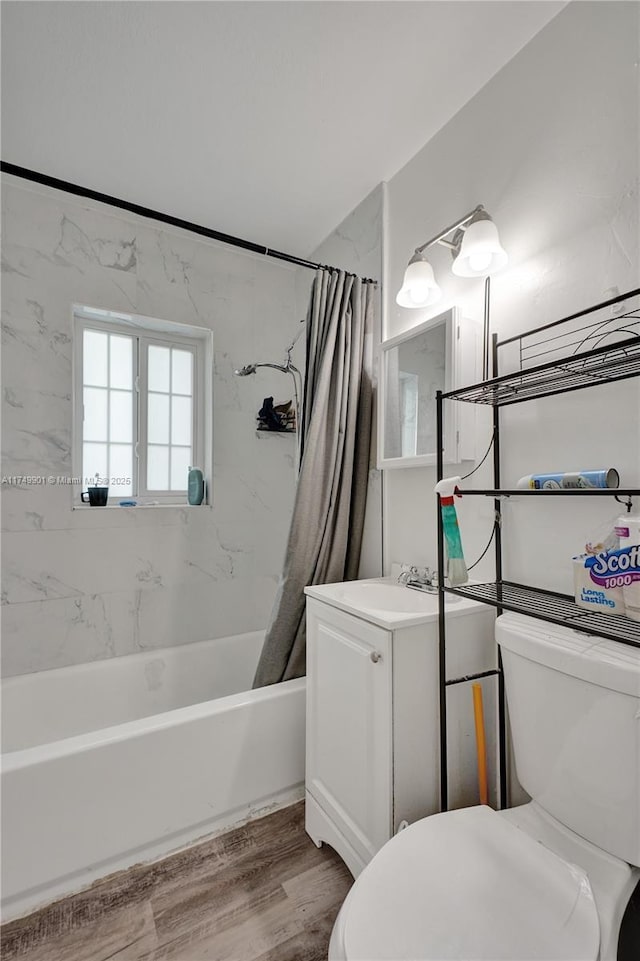 full bathroom featuring toilet, wood finished floors, vanity, and shower / bath combination with curtain