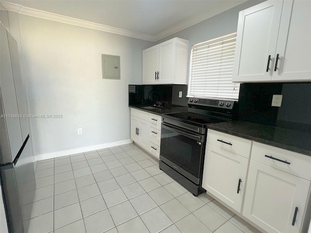 kitchen featuring stainless steel electric stove, dark countertops, backsplash, white cabinets, and a sink