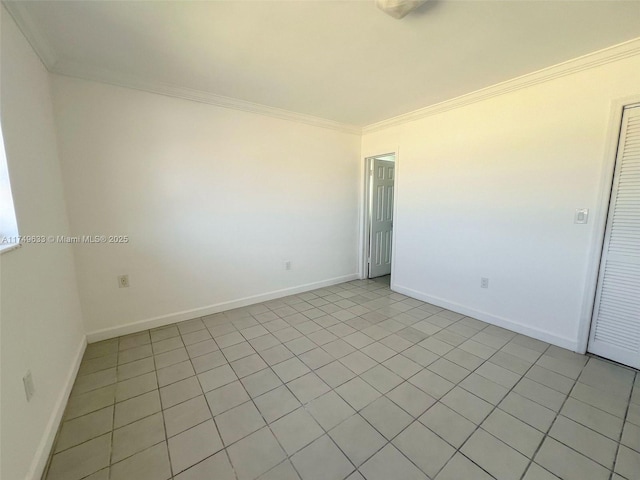 unfurnished room featuring baseboards and crown molding