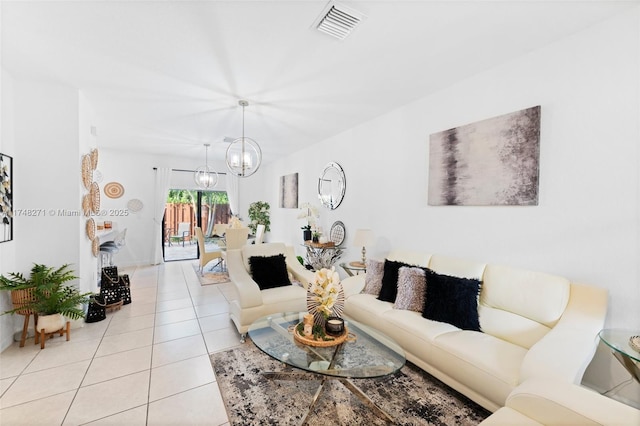 living area featuring light tile patterned floors, visible vents, and a notable chandelier