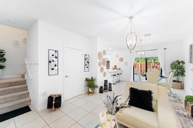 living room with light tile patterned floors, visible vents, stairway, a chandelier, and baseboards