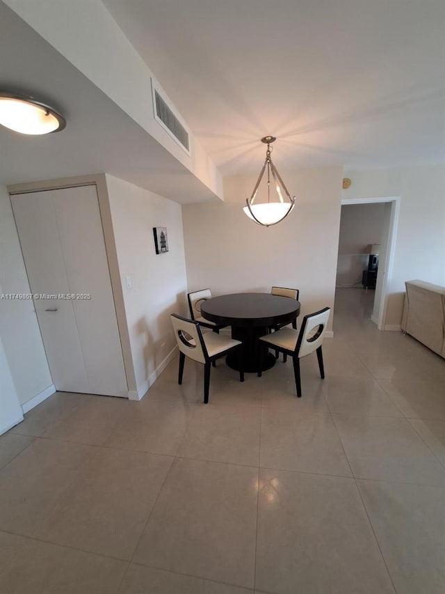 dining area with visible vents, baseboards, and light tile patterned floors