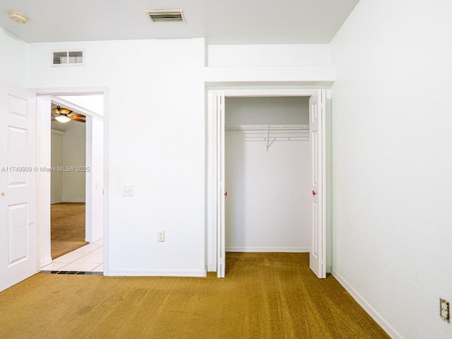 unfurnished bedroom with light carpet, baseboards, visible vents, and a closet