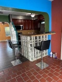 bar featuring stainless steel microwave and mail area