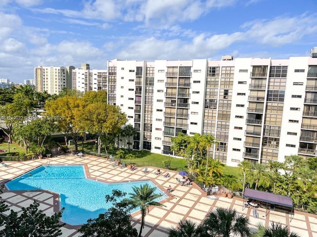 pool with a patio and a city view