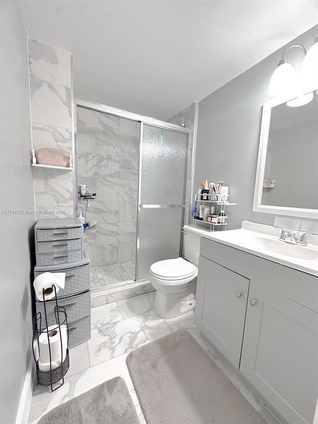 full bath with marble finish floor, vanity, a shower stall, and toilet