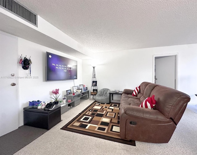 carpeted living area with visible vents and a textured ceiling