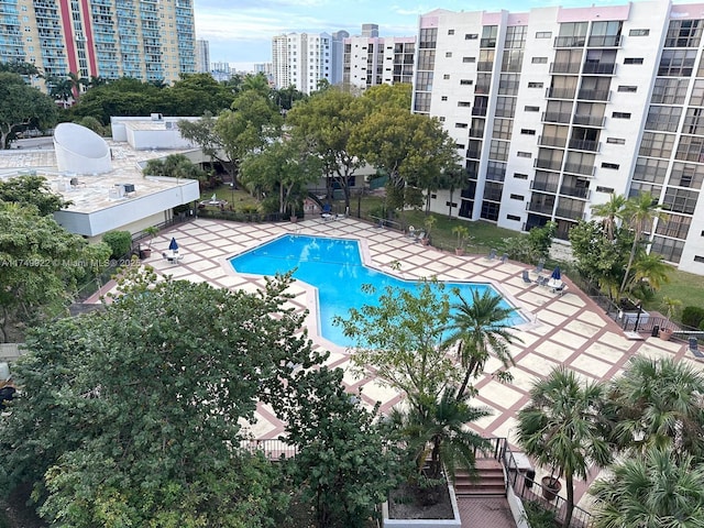 pool featuring a view of city, fence, and a patio