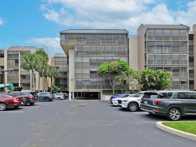 view of building exterior featuring uncovered parking