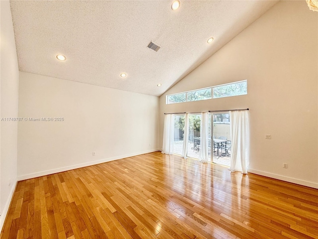spare room featuring recessed lighting, light wood-style floors, visible vents, and a textured ceiling