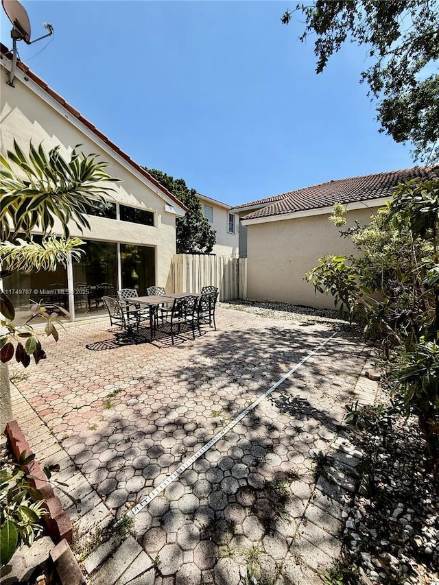 view of patio / terrace with outdoor dining area and fence