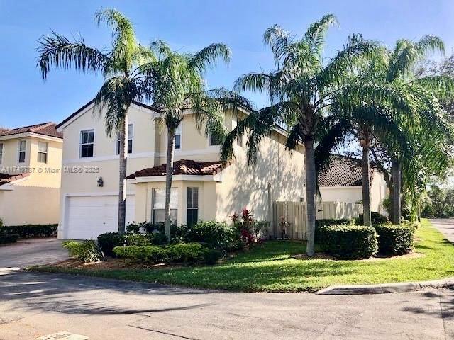mediterranean / spanish-style house featuring fence, an attached garage, driveway, and stucco siding