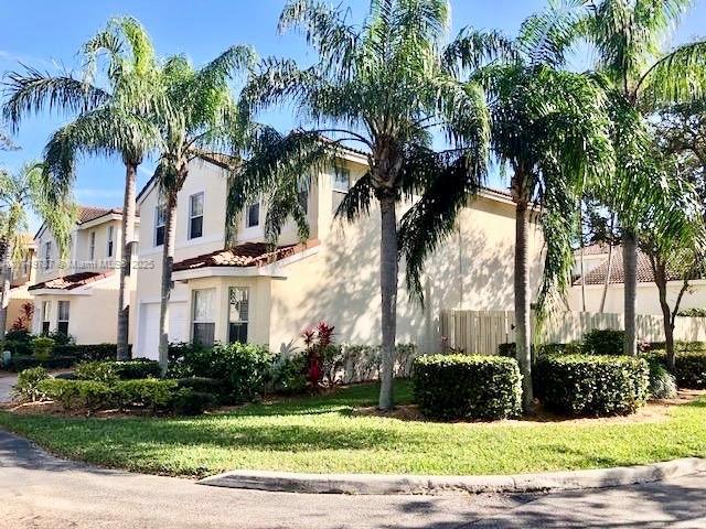 view of property exterior with stucco siding, a tile roof, and fence