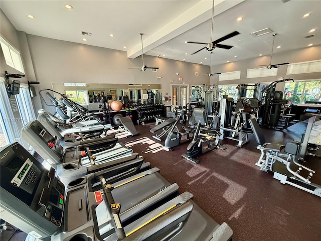 workout area with a high ceiling, a ceiling fan, visible vents, and recessed lighting