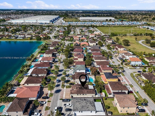 birds eye view of property with a residential view and a water view