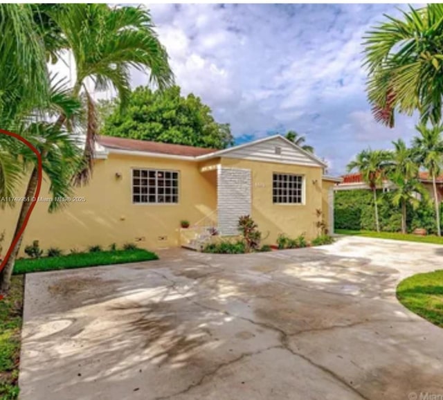 view of front of house with concrete driveway and stucco siding