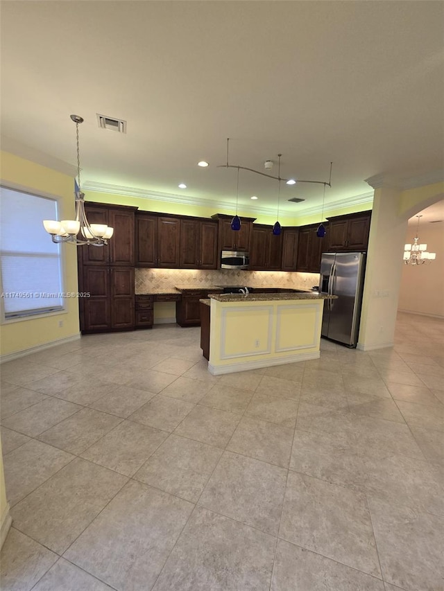 kitchen with decorative light fixtures, tasteful backsplash, visible vents, appliances with stainless steel finishes, and dark brown cabinets