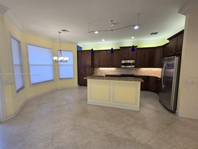 kitchen with a kitchen island with sink, appliances with stainless steel finishes, visible vents, and decorative light fixtures