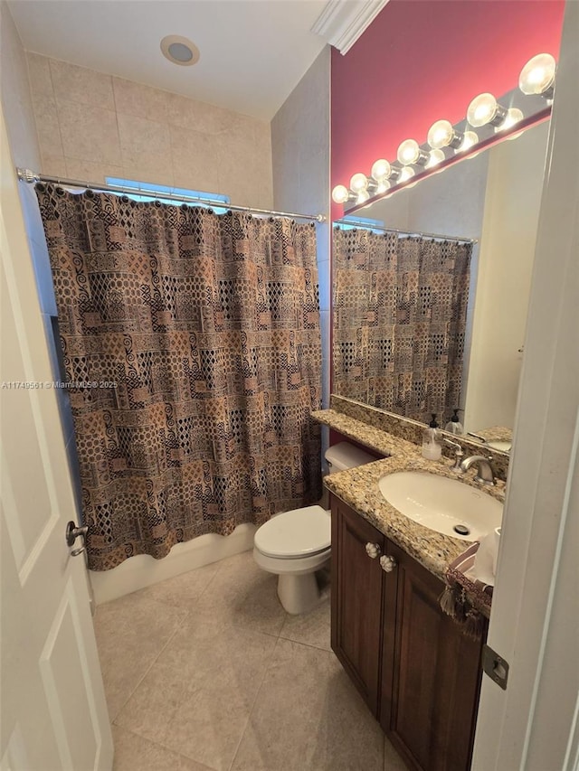 bathroom featuring toilet, tile patterned flooring, shower / bath combo with shower curtain, and vanity