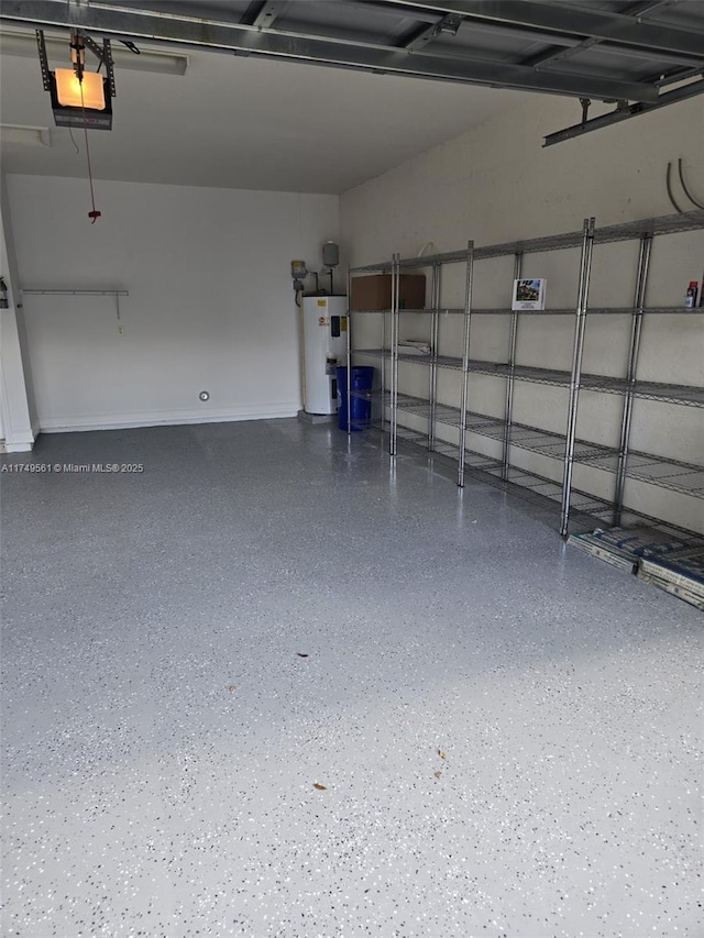 garage with a garage door opener and electric water heater