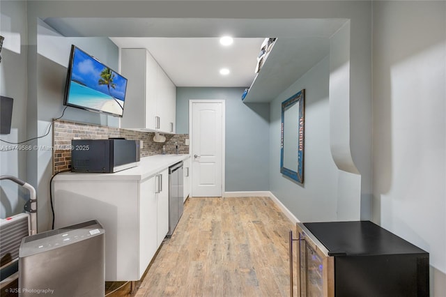 clothes washing area featuring recessed lighting, light wood-style floors, and baseboards
