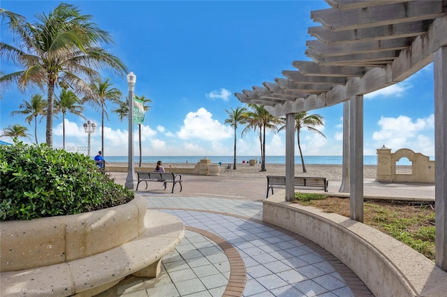 view of community featuring a pergola and a water view