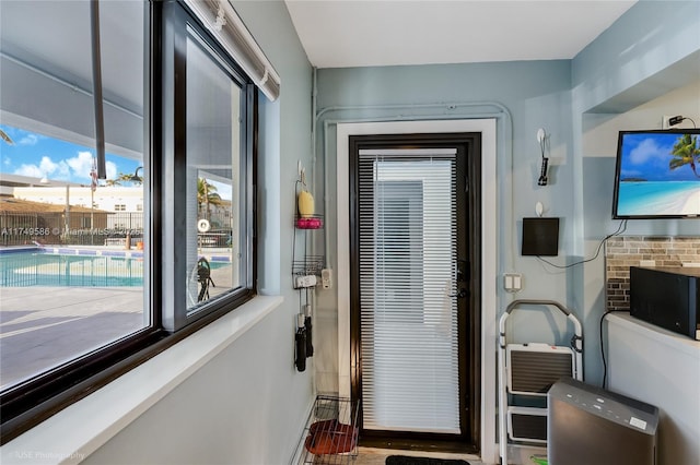 entryway featuring a wealth of natural light and baseboards