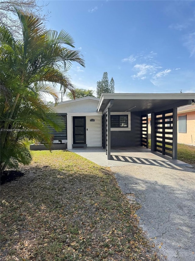 contemporary house featuring driveway and an attached carport