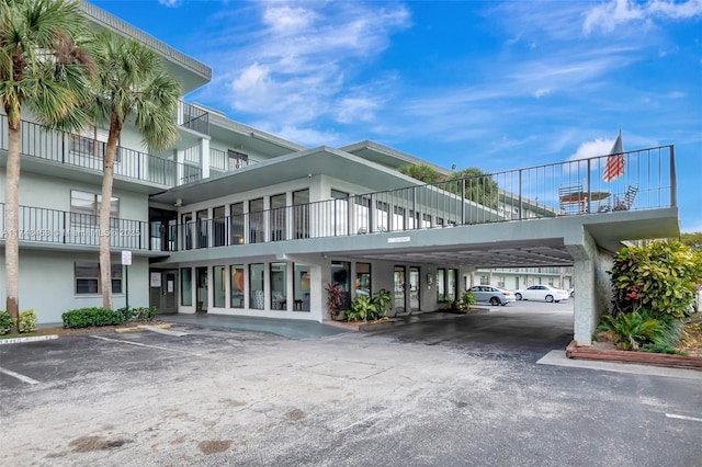 view of property featuring uncovered parking