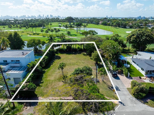 aerial view with a view of city, golf course view, and a water view