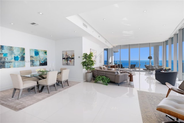 dining area with recessed lighting, a water view, visible vents, and floor to ceiling windows