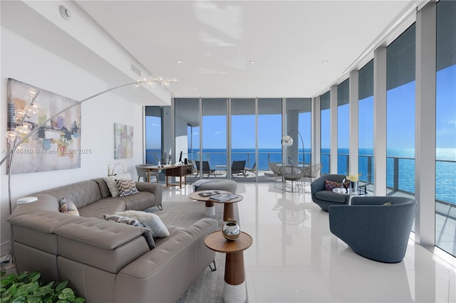 living area featuring a water view, tile patterned flooring, expansive windows, and visible vents