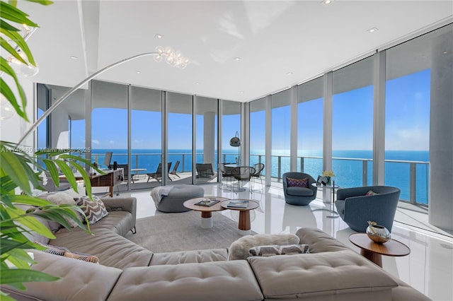 living room featuring a water view, tile patterned flooring, and floor to ceiling windows