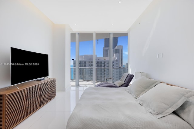 bedroom featuring access to exterior, a view of city, floor to ceiling windows, and light tile patterned flooring