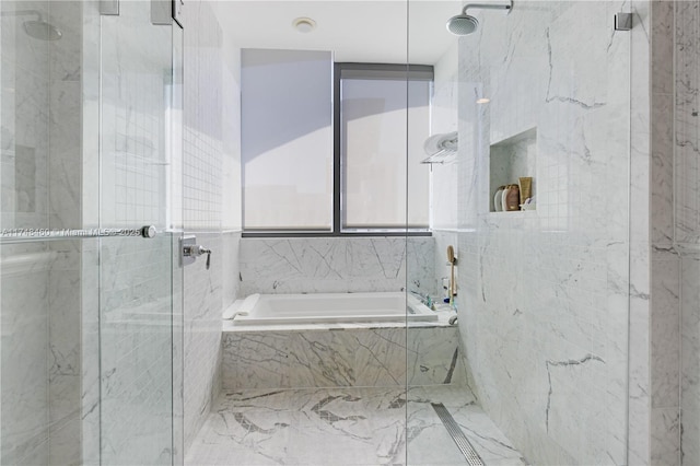 bathroom featuring a marble finish shower and a bath