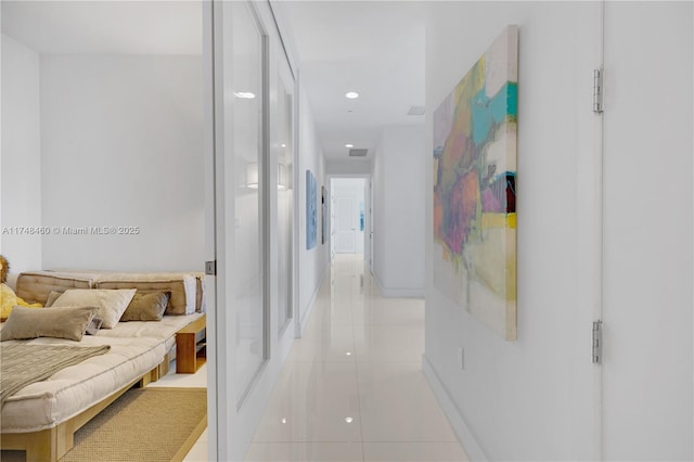 corridor with recessed lighting, visible vents, baseboards, and light tile patterned floors