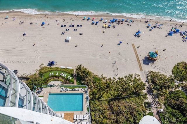 drone / aerial view featuring a water view and a beach view