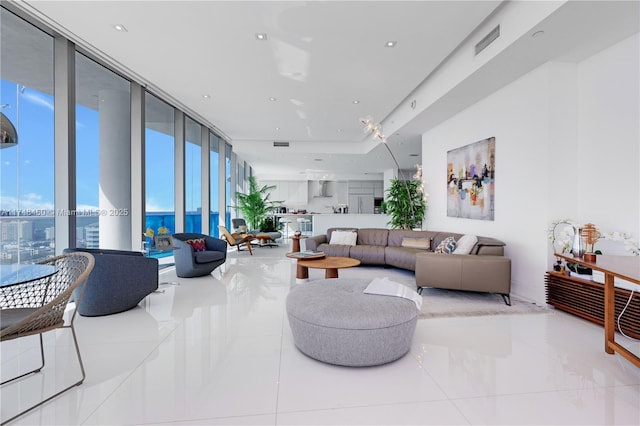 living area with visible vents and floor to ceiling windows