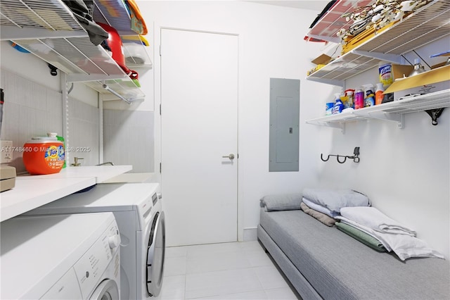 laundry room with laundry area, electric panel, independent washer and dryer, and light tile patterned flooring