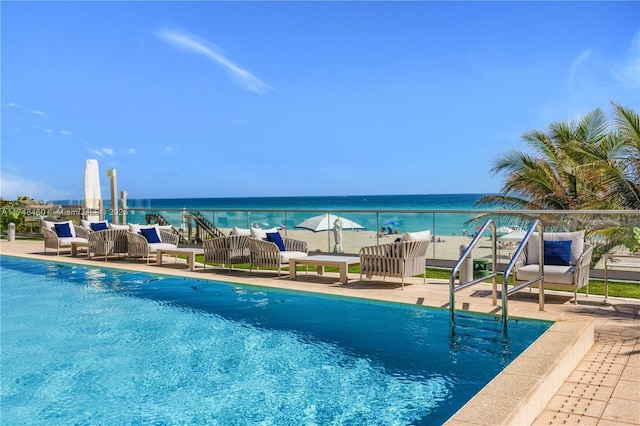 view of swimming pool featuring a water view