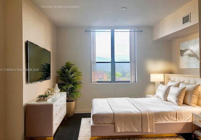 bedroom featuring visible vents and baseboards