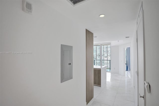 hallway featuring light tile patterned floors, electric panel, and visible vents