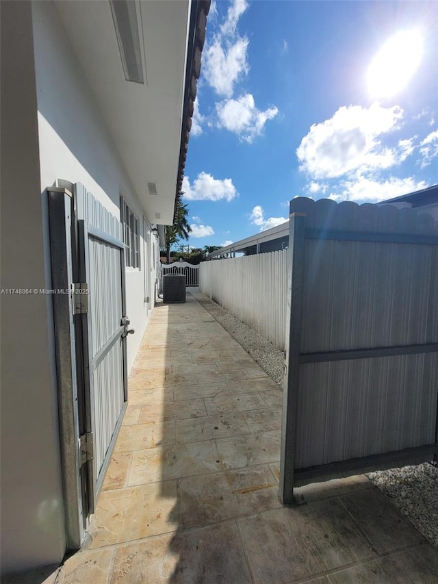 exterior space featuring fence, a gate, and stucco siding